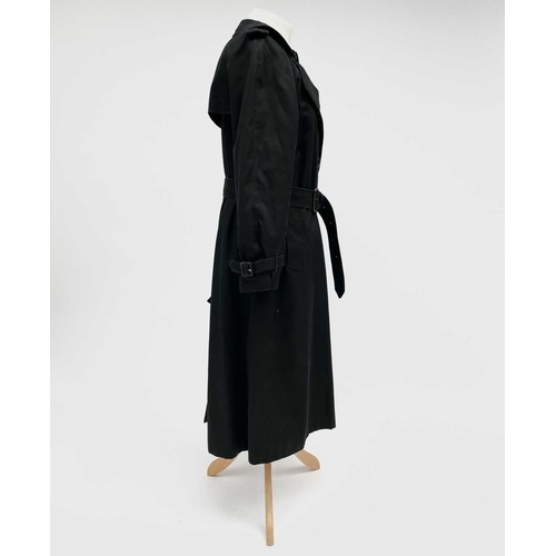 2823 - A ladies Burberry Prorsum black belted trench raincoat with Burberry check lining, label size long 1... 