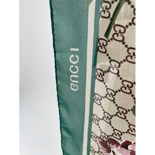 2825 - A Gucci 'Gucci Blooms' design silk scarf, with tags. 89 x 181cm.