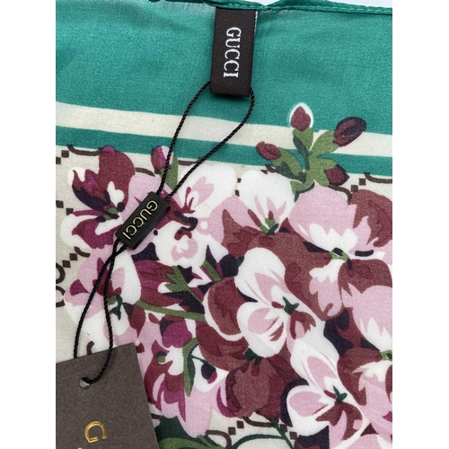 2825 - A Gucci 'Gucci Blooms' design silk scarf, with tags. 89 x 181cm.