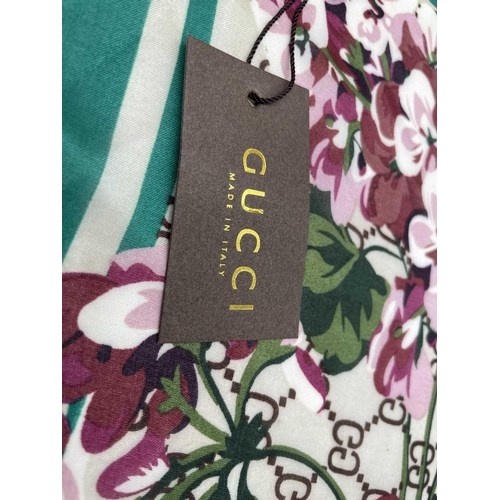 2825 - A Gucci 'Gucci Blooms' design silk scarf, with tags. 89 x 181cm.