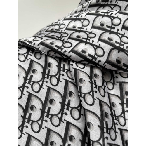 2826 - A Christian Dior monochrome monogram design silk scarf, with tags. 90 x 177cm.