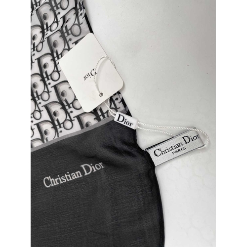 2826 - A Christian Dior monochrome monogram design silk scarf, with tags. 90 x 177cm.