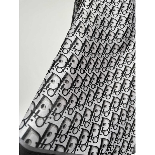 2826 - A Christian Dior monochrome monogram design silk scarf, with tags. 90 x 177cm.