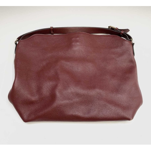 2827 - A Mulberry grained red leather handbag with gold coloured hardware. 32cm x 44cm (excluding strap).