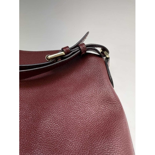 2827 - A Mulberry grained red leather handbag with gold coloured hardware. 32cm x 44cm (excluding strap).