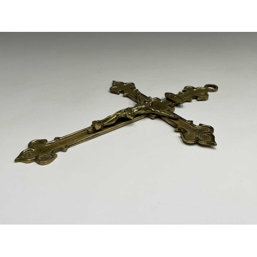 283 - A 20th century cast brass wall hanging crucifix, height 32cm, together with two large prints of a re... 