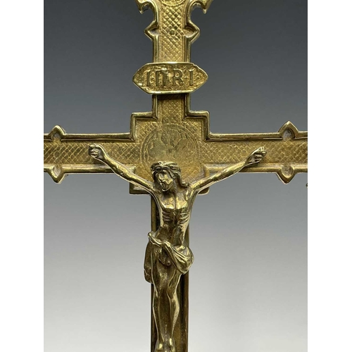 283 - A 20th century cast brass wall hanging crucifix, height 32cm, together with two large prints of a re... 