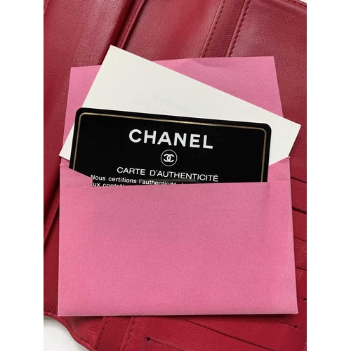 2832 - Chanel. Cerise pink lambskin leather wallet, embossed bow design to reverse, grey silver hardware, w... 