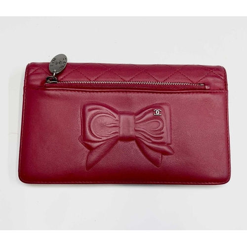 2832 - Chanel. Cerise pink lambskin leather wallet, embossed bow design to reverse, grey silver hardware, w... 