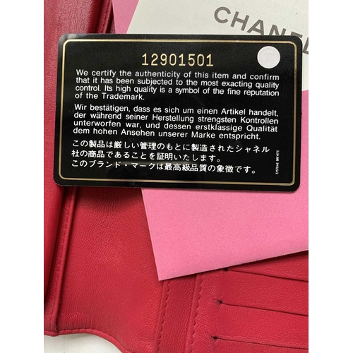 2832 - Chanel. Cerise pink lambskin leather wallet, embossed bow design to reverse, grey silver hardware, w... 