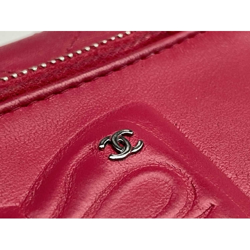 2832 - Chanel. Cerise pink lambskin leather wallet, embossed bow design to reverse, grey silver hardware, w... 