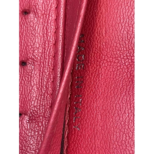 2832 - Chanel. Cerise pink lambskin leather wallet, embossed bow design to reverse, grey silver hardware, w... 