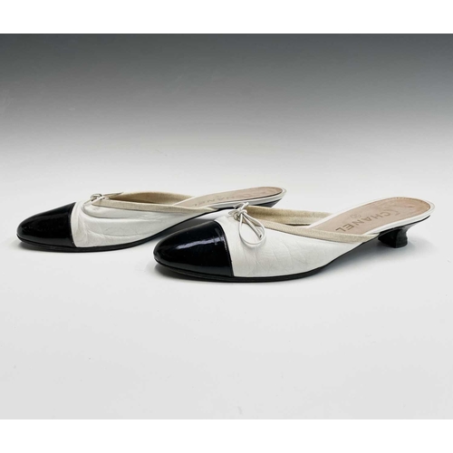 2834 - Chanel Shoes. Classic Chanel two tone kitten heel mules. White leather, with white bow, silk trim an... 