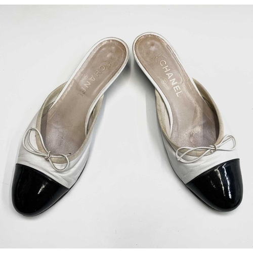 2834 - Chanel Shoes. Classic Chanel two tone kitten heel mules. White leather, with white bow, silk trim an... 