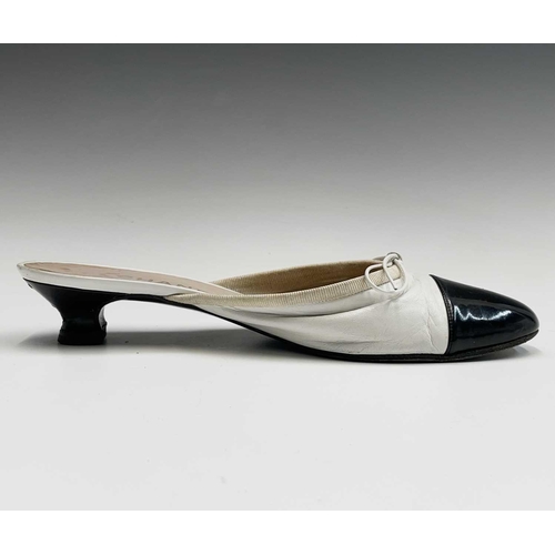 2834 - Chanel Shoes. Classic Chanel two tone kitten heel mules. White leather, with white bow, silk trim an... 