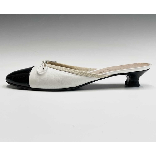 2834 - Chanel Shoes. Classic Chanel two tone kitten heel mules. White leather, with white bow, silk trim an... 