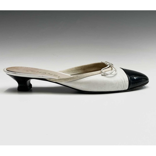 2834 - Chanel Shoes. Classic Chanel two tone kitten heel mules. White leather, with white bow, silk trim an... 