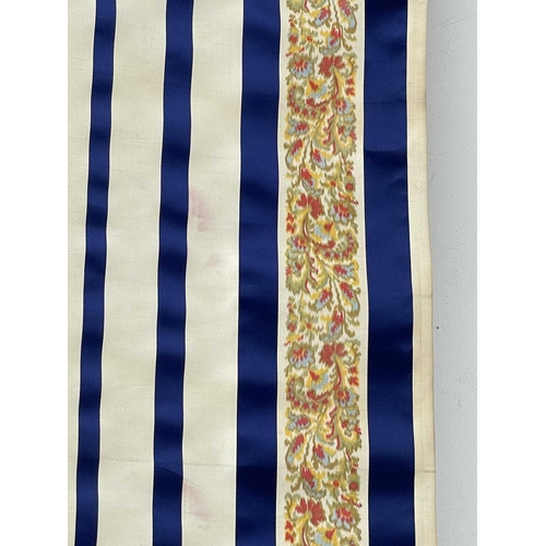 2839 - A roll of woven decorative fabric, blue and white stripes with floral border, approx 4 yards.