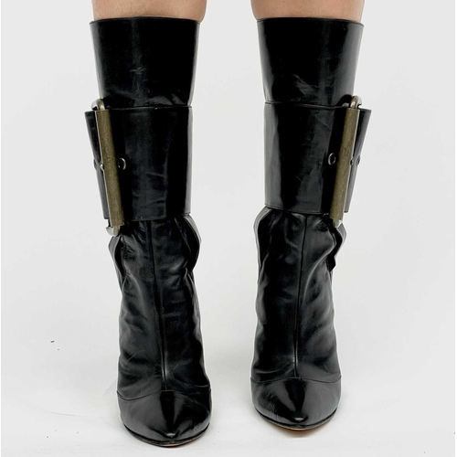 2848 - Manolo Blahnik. High heeled black leather pirate style boots, with oversized buckle feature. Rear zi... 