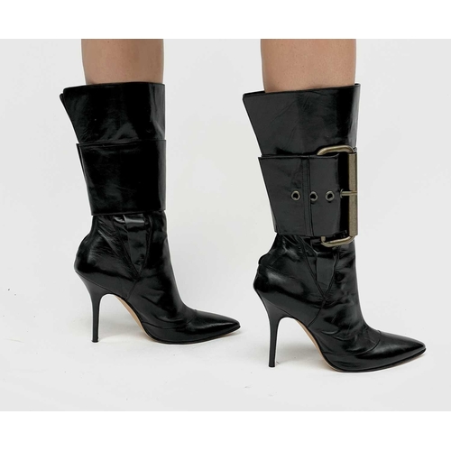 2848 - Manolo Blahnik. High heeled black leather pirate style boots, with oversized buckle feature. Rear zi... 