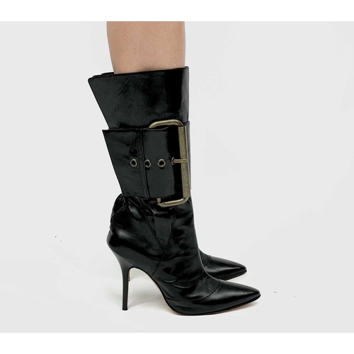 2848 - Manolo Blahnik. High heeled black leather pirate style boots, with oversized buckle feature. Rear zi... 