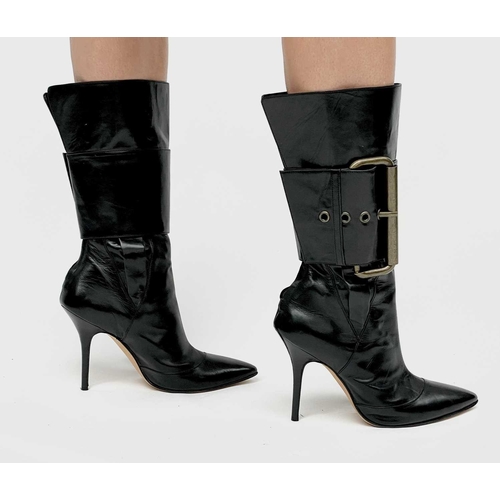 2848 - Manolo Blahnik. High heeled black leather pirate style boots, with oversized buckle feature. Rear zi... 