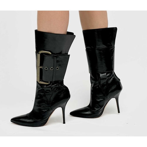 2848 - Manolo Blahnik. High heeled black leather pirate style boots, with oversized buckle feature. Rear zi... 