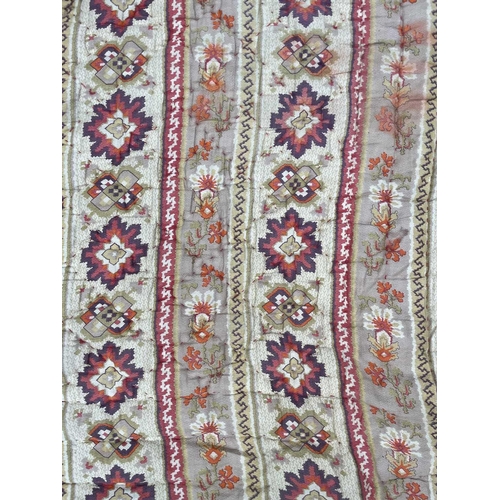 2857 - A heavy and thick red floral quilt together with a machine made tapestry style panel. The quilt 210x... 