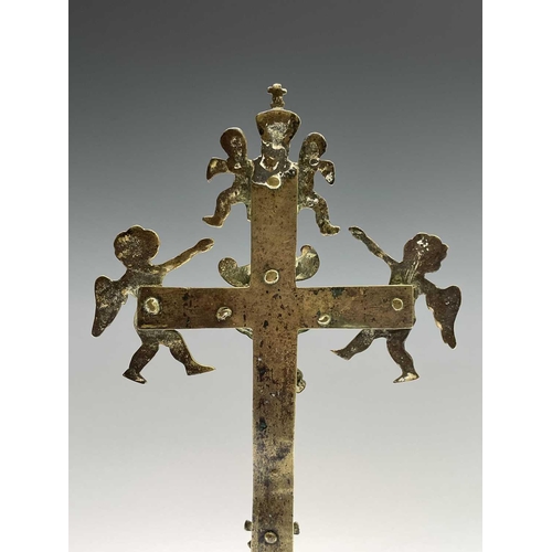 286 - A brass altar crucifix, cast with the figure of Christ beneath an INRI scroll, cherubim, and a skull... 