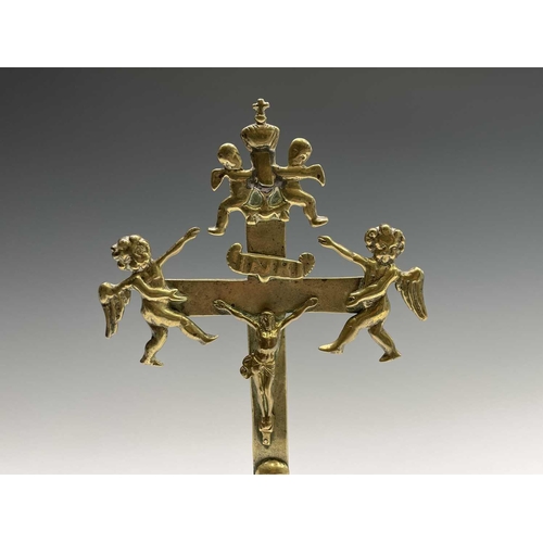 286 - A brass altar crucifix, cast with the figure of Christ beneath an INRI scroll, cherubim, and a skull... 