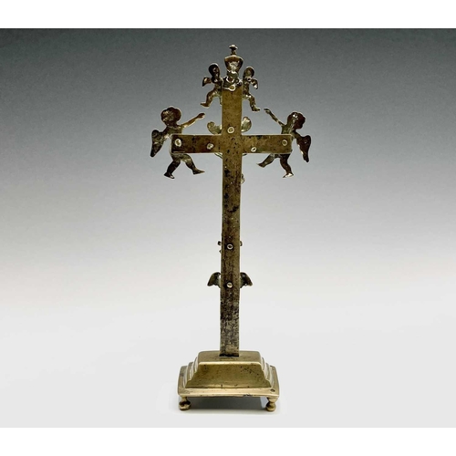 286 - A brass altar crucifix, cast with the figure of Christ beneath an INRI scroll, cherubim, and a skull... 