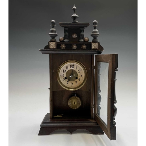 2903 - An American eight-day mantel clock, with stained pine case, striking on a coiled gong, height 56cm.