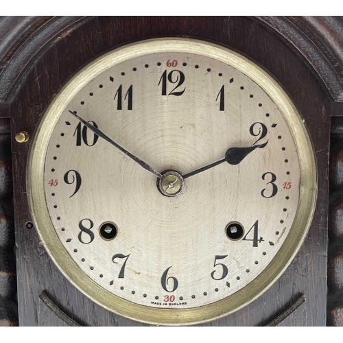 2905 - An oak cased mantel clock, with twist side supports, British Jerome movement, height 30cm.