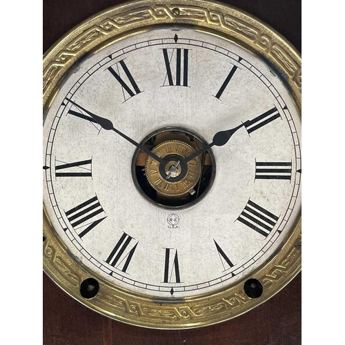 2911 - An American mantel alarm clock, by Seth Thomas, late 19th century, the walnut case with carved sides... 