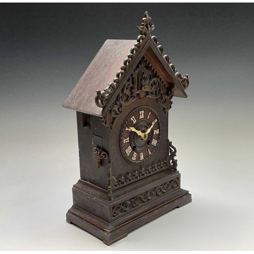 2915 - An oak and pine Black Forest cuckoo mantel clock, circa 1900, the case with carved and pierced decor... 