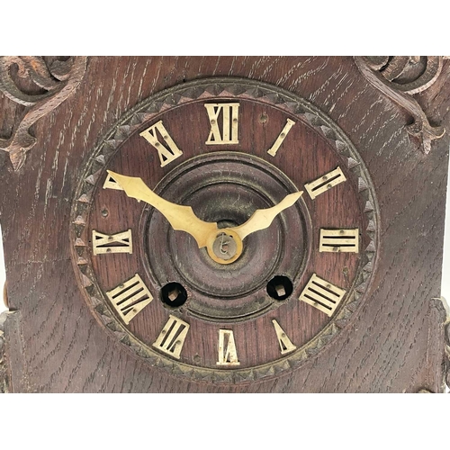 2915 - An oak and pine Black Forest cuckoo mantel clock, circa 1900, the case with carved and pierced decor... 