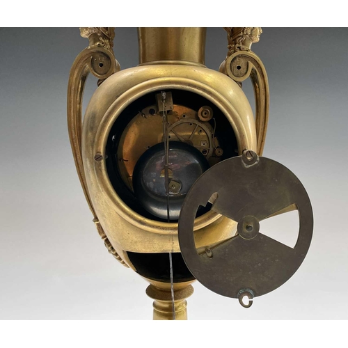 2918 - A French Empire ormolu cased mantel clock, of urn form, the covered rim applied with two winged cher... 