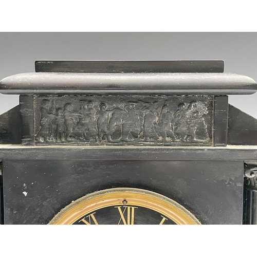 2923 - A 19th century black slate mantel clock of architectural form, with relief moulded spelter tablet an... 