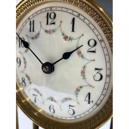 2928 - A 400 day brass torsion mantel clock, of portico type, with domed top, floral garland decorated dial... 