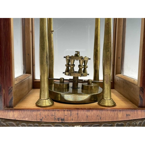 2929 - A walnut cased 400 day torsion clock, circa 1920, the brass framed circular copper dial with blue an... 