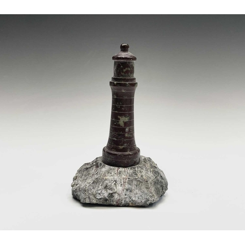 296 - A collection of 18 small Cornish serpentine models of lighthouses, the tallest 15cm, and a turned se... 