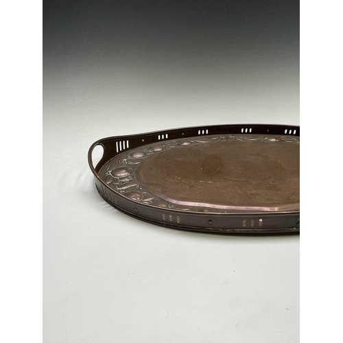 3 - A Newlyn copper oval tray, circa 1910, the raised edge with twin handles, the border repousse decora... 