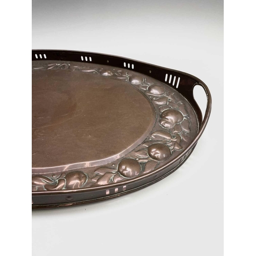 3 - A Newlyn copper oval tray, circa 1910, the raised edge with twin handles, the border repousse decora... 