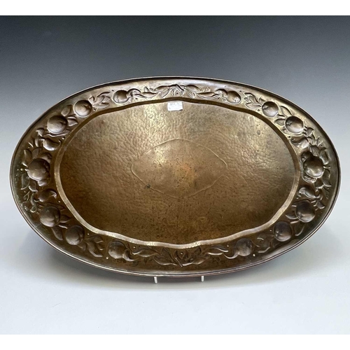 3 - A Newlyn copper oval tray, circa 1910, the raised edge with twin handles, the border repousse decora... 