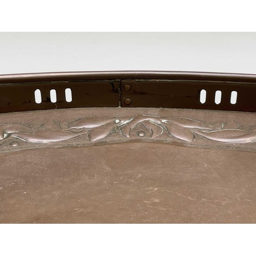 3 - A Newlyn copper oval tray, circa 1910, the raised edge with twin handles, the border repousse decora... 