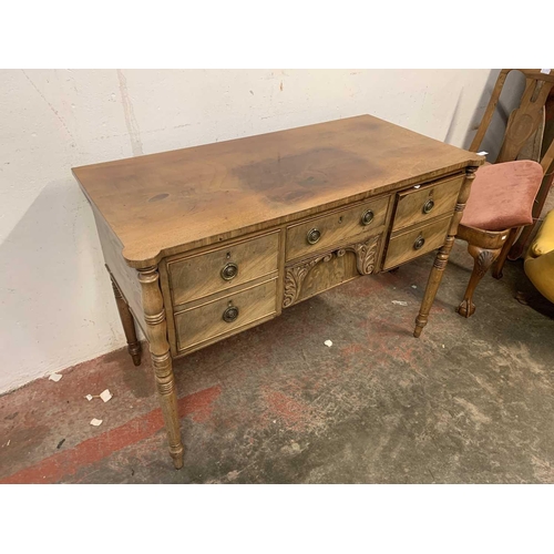 3012 - A late Georgian mahogany sideboard, of small proportions, with five drawers surrounding a leaf carve... 