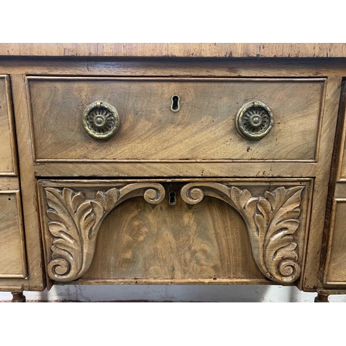 3012 - A late Georgian mahogany sideboard, of small proportions, with five drawers surrounding a leaf carve... 