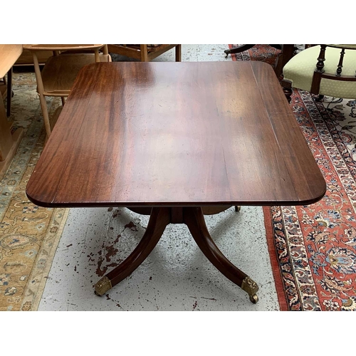 3013 - A George IV mahogany tilt top supper table, with rounded corners, on a tapering octagonal pillar and... 