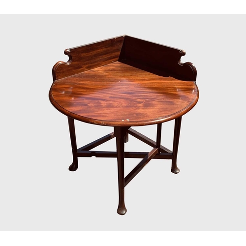 3015 - A mahogany Corner table, in early George III style and incorporating some period elements, with rais... 