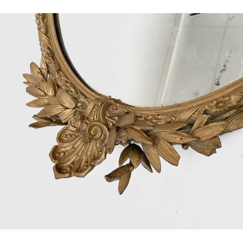 3016 - A Victorian oval gilt wall mirror, the gesso frame moulded with ribbons and flowerheads, height 84cm... 